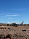 General aviation, small airplane at airfield in desert in Africa. Cessna 172. Royalty Free Stock Photo