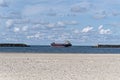 General cargo ship ship leaving port against cloudy sky