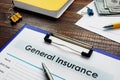 General insurance form with pen and cash.