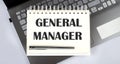 GENERAL MANAGER - Top view notebook writing on the laptop Royalty Free Stock Photo