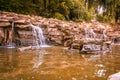 Small waterfall and potamic in the city park, with nobody. Royalty Free Stock Photo