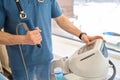 General practitioner adjusting extracorporeal shockwave therapy machine