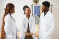 General practitioner and doctor and nurse as african american medical team at hospital. Royalty Free Stock Photo