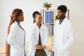 General practitioner and doctor and nurse as african american medical team at hospital. Royalty Free Stock Photo