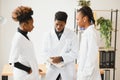 General practitioner and doctor and nurse as african american medical team at hospital. Royalty Free Stock Photo