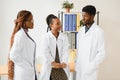 General practitioner and doctor and nurse as african american medical team at hospital. Royalty Free Stock Photo