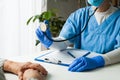 General Practitioner in doctor`s office, physician performing a blood pressure checkup