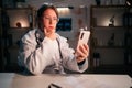 General practitioner or doctor thinking new idea using smartphone on workplace working during night shift in hospital Royalty Free Stock Photo