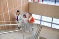 General practitioner escorting little patient with her mother to exam room