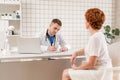 General Practitioner. Male physician and female patient. Patient Having Consultation With male Doctor In Office Royalty Free Stock Photo