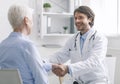 General practitioner shaking hands with healthy patient Royalty Free Stock Photo