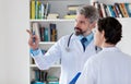 General practitioner talking with medical student about therapy of patient Royalty Free Stock Photo