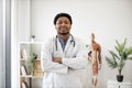 General practitioner in white coat posing in doctor's office Royalty Free Stock Photo