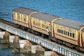 A general , unreserved class commuter doing un-necessary, dangerous stunts in the train door on Pamban rail sea bridge Royalty Free Stock Photo