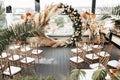 General view of decorated terrace, arch of flowers and chairs stylised in luxury gold tone. Modern decoration concept.