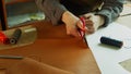 General view of the tanner`s desktop, which is preparing to create designer shoes made of genuine leather. Cuts leather