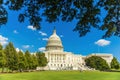 Capitol Building in Washington, DC, USA with leafy green summer trees in the foreground