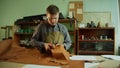 General view of the workshop and workbench of a shoemaker who prepares natural leather to create an exclusive product