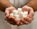 Cupped hands holding white sugar cubes Royalty Free Stock Photo