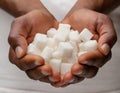 Cupped hands holding white sugar cubes Royalty Free Stock Photo