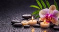 Beautiful long spa background with massage stones, candles, pink orchid and drops of waters on black backdrop. Space for text Royalty Free Stock Photo