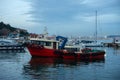 Evening at the Harbor: Red Fishing Boat and Sailboats Royalty Free Stock Photo