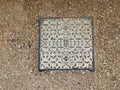 eOld manhole cover on the ground in the park Royalty Free Stock Photo