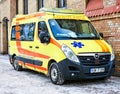 Yellow and red emergency ambulance on the streets of the city of Riga