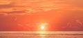 Golden sunrise sky background over sea in the morning with beautiful sunlight reflection on water surface in panoramic view Royalty Free Stock Photo