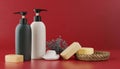 Bottles of shampoo and soap bars on red background with copy space Royalty Free Stock Photo