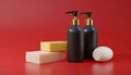 Bottles of shampoo and soap bars on red background with copy space Royalty Free Stock Photo