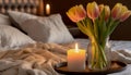 Burning candle and vase with tulips on bed, closeup Royalty Free Stock Photo