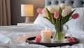 Burning candle and vase with tulips on bed, closeup Royalty Free Stock Photo