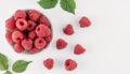 Top view of fresh ripe raspberries on white background with copy space