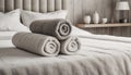 Rolled clean terry towels on bed with copy space