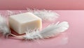 White soap bar and feathers on pink background with copy space Royalty Free Stock Photo