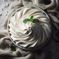 Bowl of whipped cream is nestled in fabric on surface