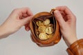 A brown leather coin purse that is filled with golden Bitcoins Royalty Free Stock Photo