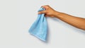 arm holding light blue microfiber cloth Royalty Free Stock Photo