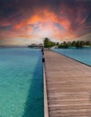 Colourful sunset at the maldive island with a boat and boardwalk Royalty Free Stock Photo