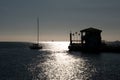 Sunset over the sea, a boat passing to ferry dock. Royalty Free Stock Photo