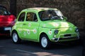 a small, green car painted with daisies Royalty Free Stock Photo