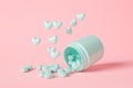 Open pastel blue medical pill with many hearts falling out. Royalty Free Stock Photo