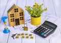 Home loan concept. Wooden house, calculator, hourglass, house keys, documents, design, potted flowerGenerated image