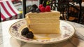 Slice of Tres Leches cake on a Parisian cafe table, bathed in warm afternoon sunlight.