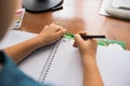 he child writes letters on a white sheet of paper Royalty Free Stock Photo