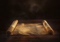 Ancient Revelations. Upon a wooden table, an unfurled parchment displays holy verses from the Torah or Pentateuch Royalty Free Stock Photo