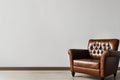 Living room. Living room with leather armchair on empty wall background. Royalty Free Stock Photo