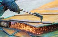 Close up of welder hand is cutting iron plate with acetylene gas welding torch machine at outdoor workshop Royalty Free Stock Photo