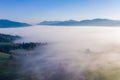 Fog. Surreal beautiful forest with fog. Aerial view. Beautiful sunrise above the forest with heavy fog Royalty Free Stock Photo